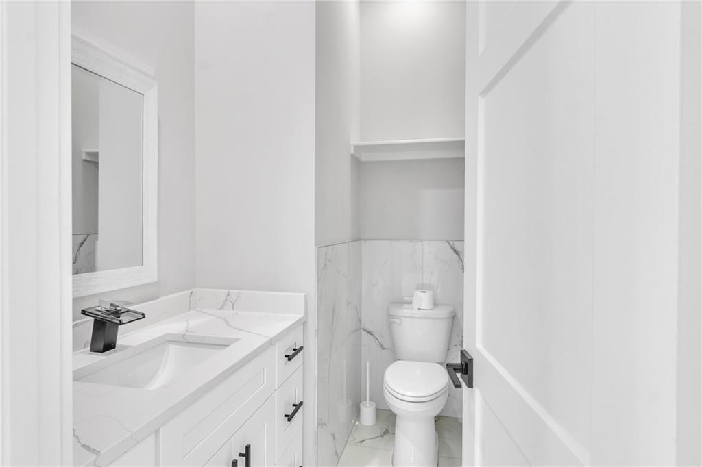 3671 Hamilton Mill Road Buford, GA 30519 - Photo 19 of 111 a bathroom with a sink toilet and a mirror