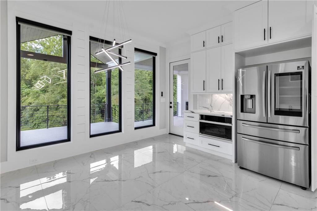 3671 Hamilton Mill Road Buford, GA 30519 - Photo 21 of 111 a kitchen with stainless steel appliances a refrigerator sink and cabinets