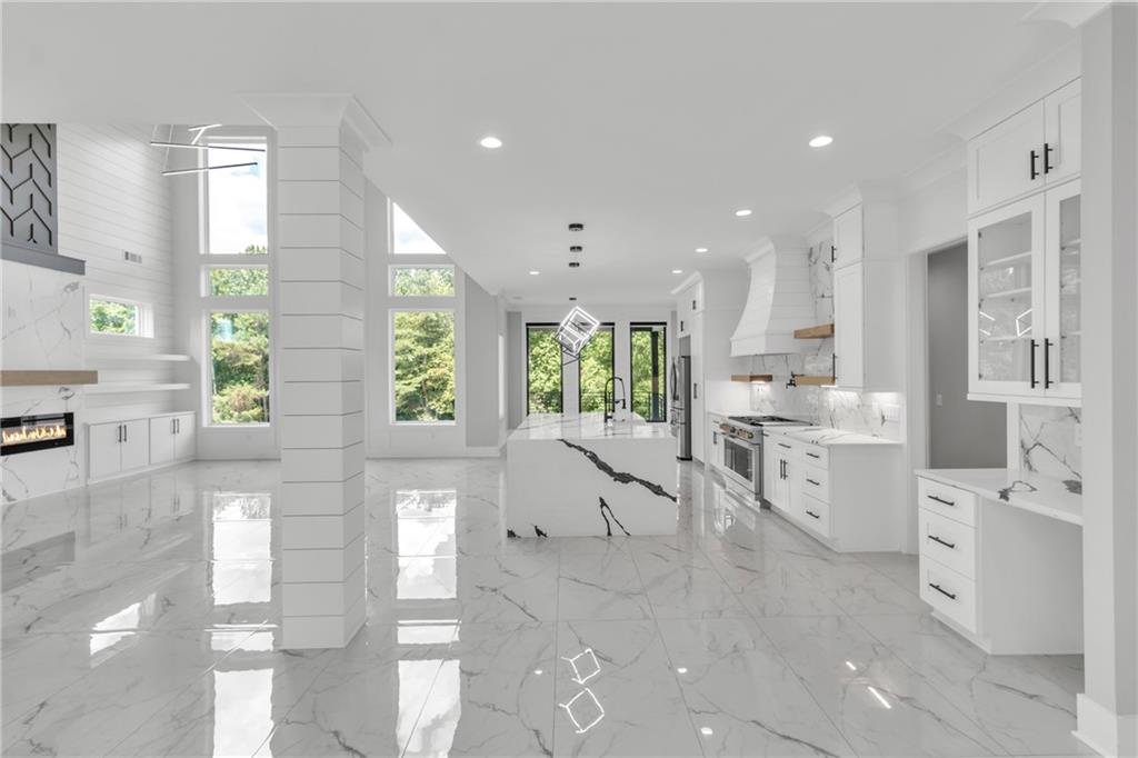 3671 Hamilton Mill Road Buford, GA 30519 - Photo 22 of 111 a large white kitchen with lots of counter space a sink and appliances