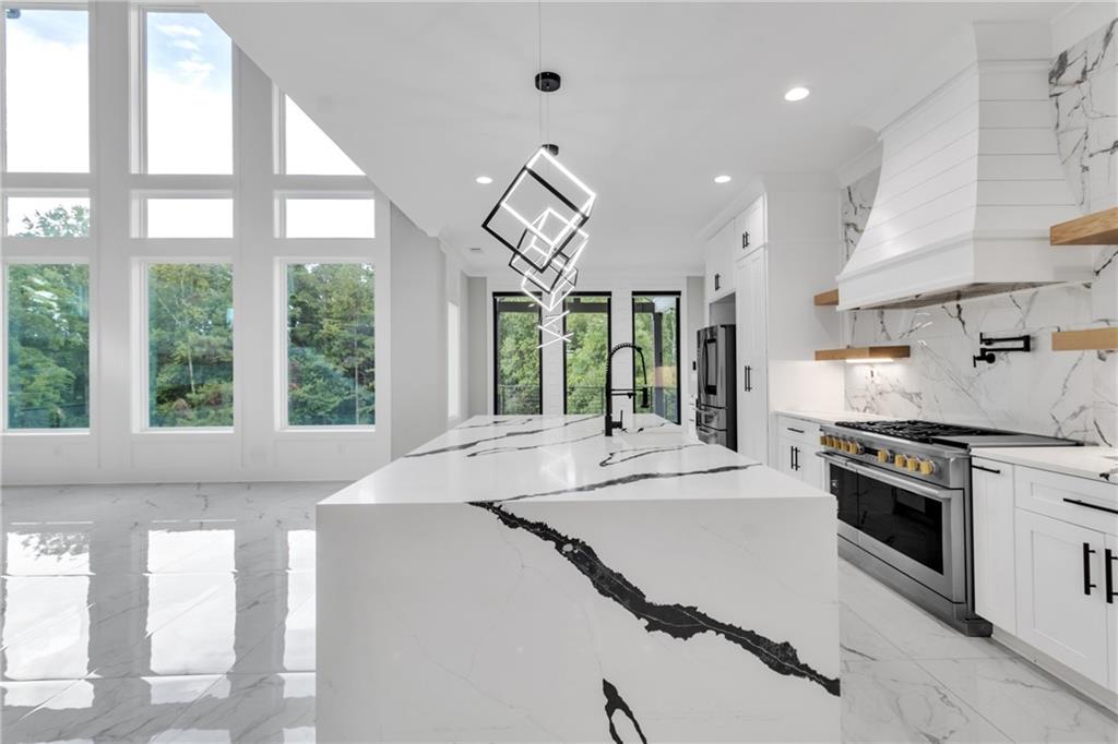 3671 Hamilton Mill Road Buford, GA 30519 - Photo 28 of 111 a kitchen with stainless steel appliances granite countertop a stove a sink and a refrigerator