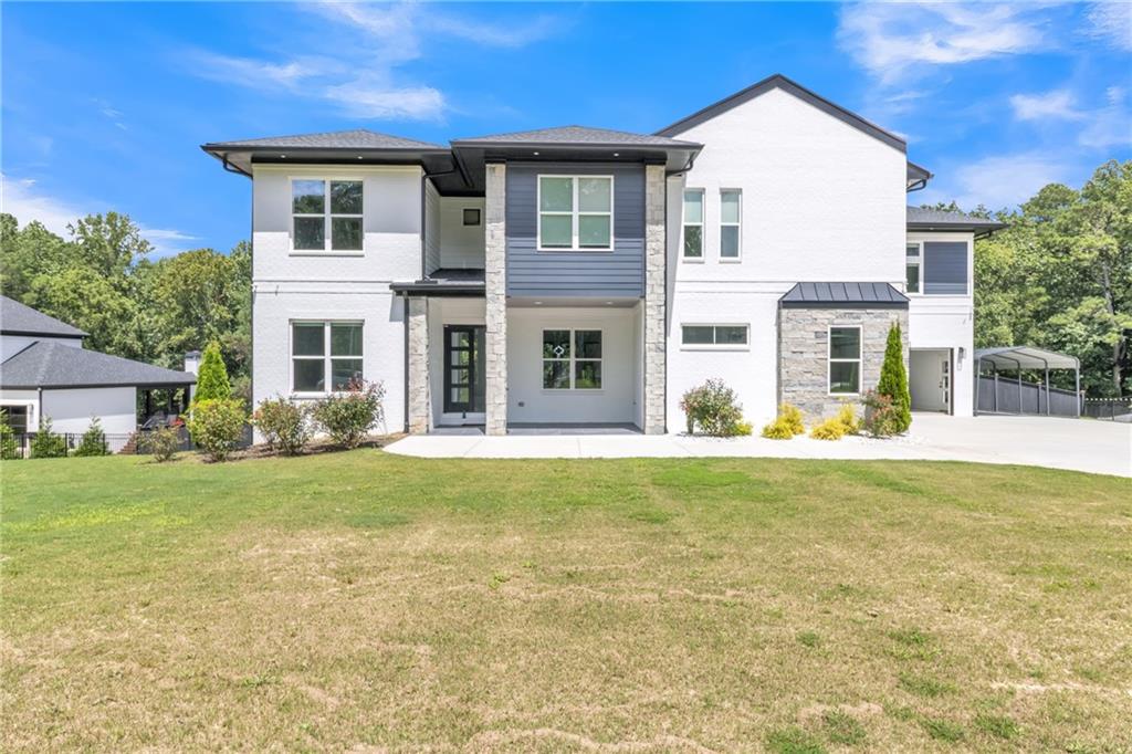 3671 Hamilton Mill Road Buford, GA 30519 - Photo 3 of 111 a front view of a house with a yard
