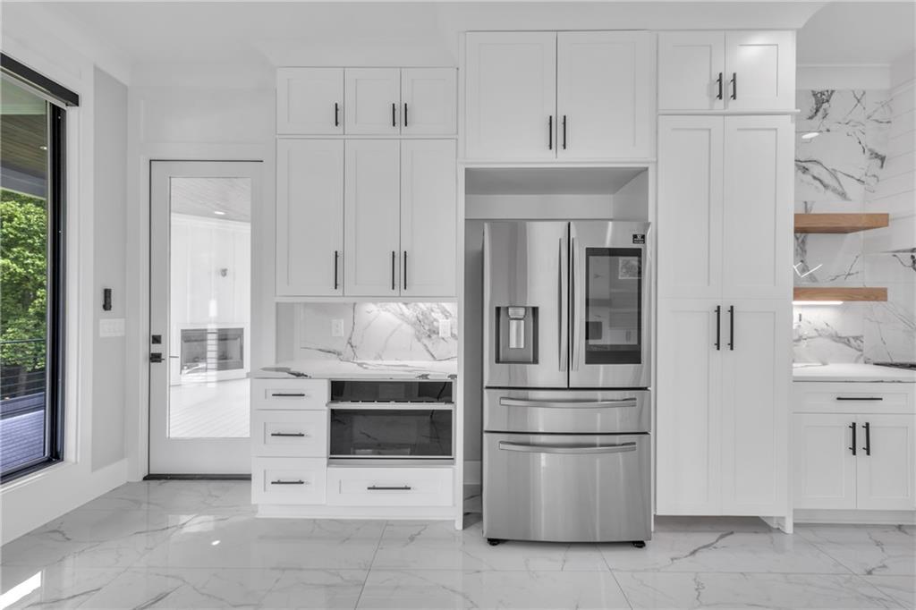 3671 Hamilton Mill Road Buford, GA 30519 - Photo 31 of 111 a kitchen with stainless steel appliances kitchen island a refrigerator sink and stove