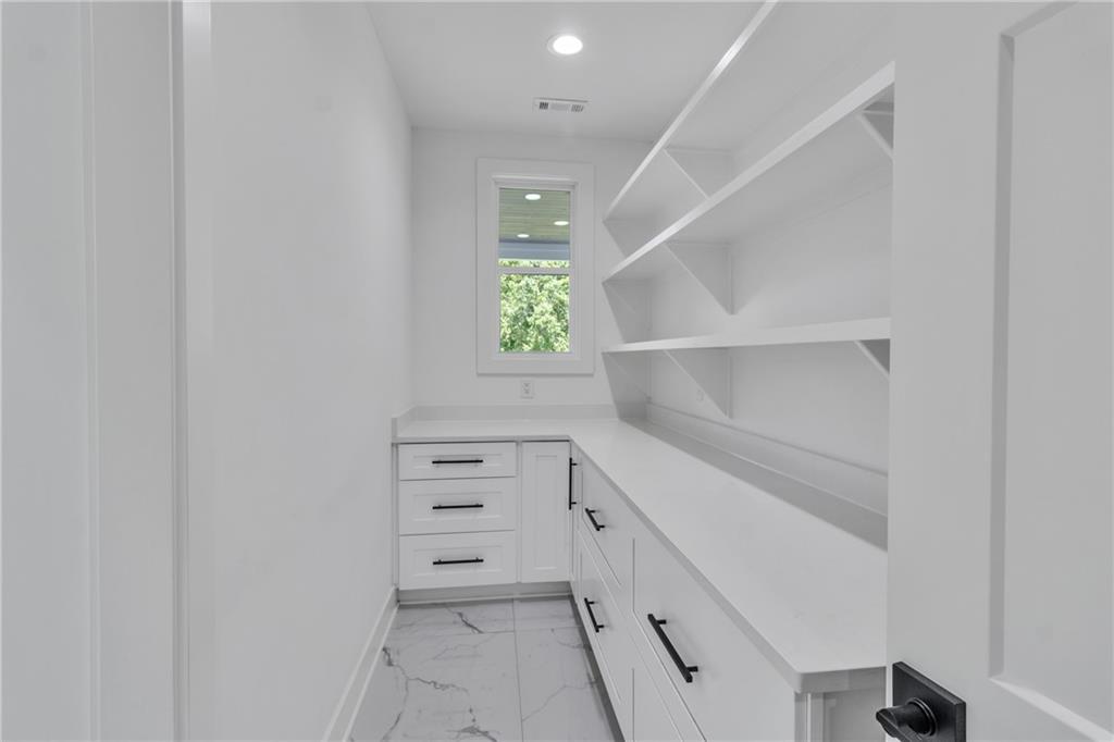 3671 Hamilton Mill Road Buford, GA 30519 - Photo 36 of 111 a view of walk in closet with clothes and shoes