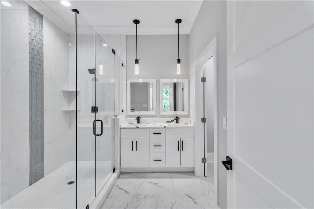 3671 Hamilton Mill Road Buford, GA 30519 - Photo 40 of 111 a bathroom with a double vanity sink mirror and shower