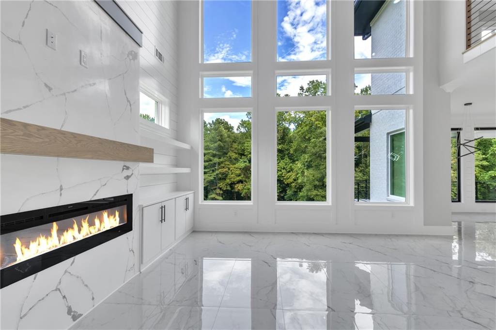 3671 Hamilton Mill Road Buford, GA 30519 - Photo 42 of 111 a view of an empty room with a fireplace and a window