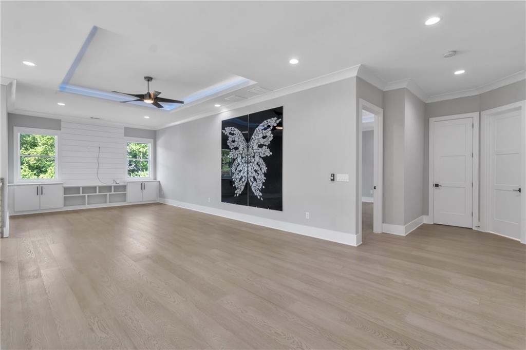 3671 Hamilton Mill Road Buford, GA 30519 - Photo 45 of 111 an empty room with windows and a ceiling fan