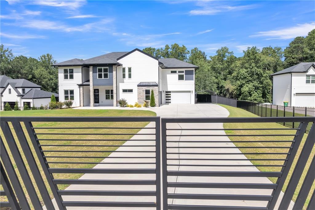 3671 Hamilton Mill Road Buford, GA 30519 - Photo 5 of 111 a front view of a house with a yard