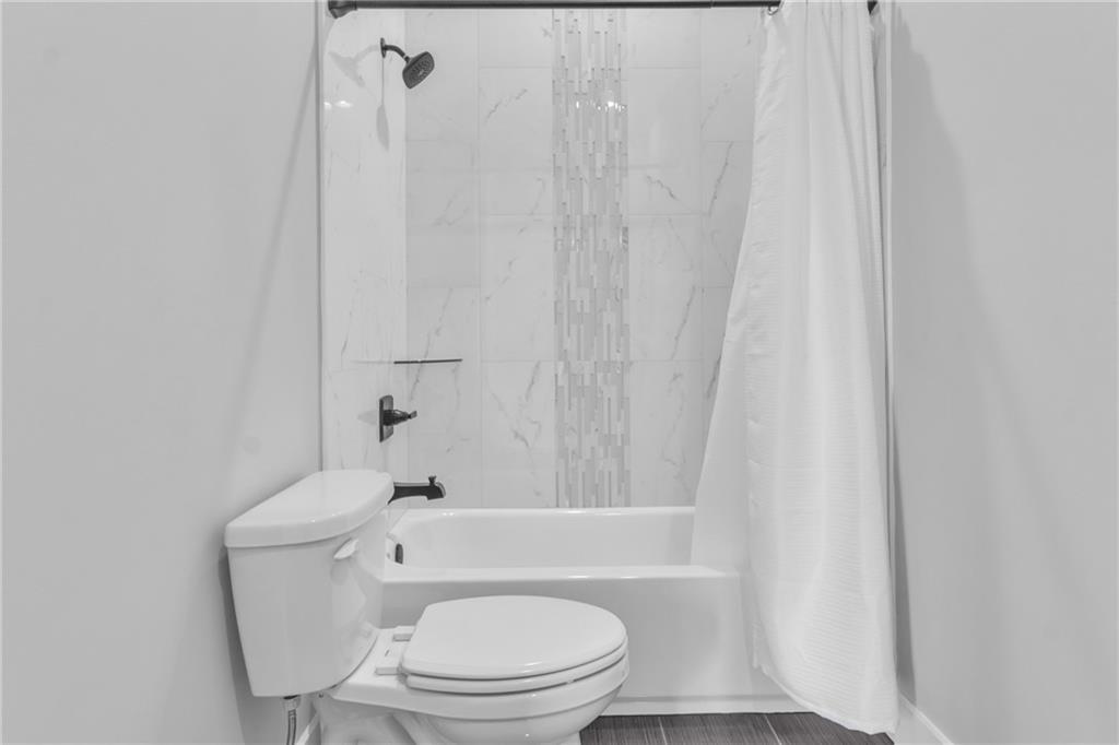 3671 Hamilton Mill Road Buford, GA 30519 - Photo 51 of 111 a white toilet sitting next to a bath tub