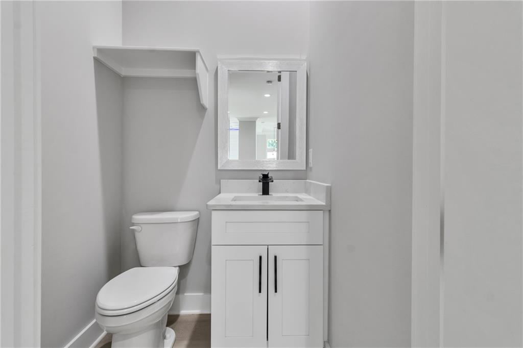 3671 Hamilton Mill Road Buford, GA 30519 - Photo 68 of 111 a bathroom with a toilet sink and mirror