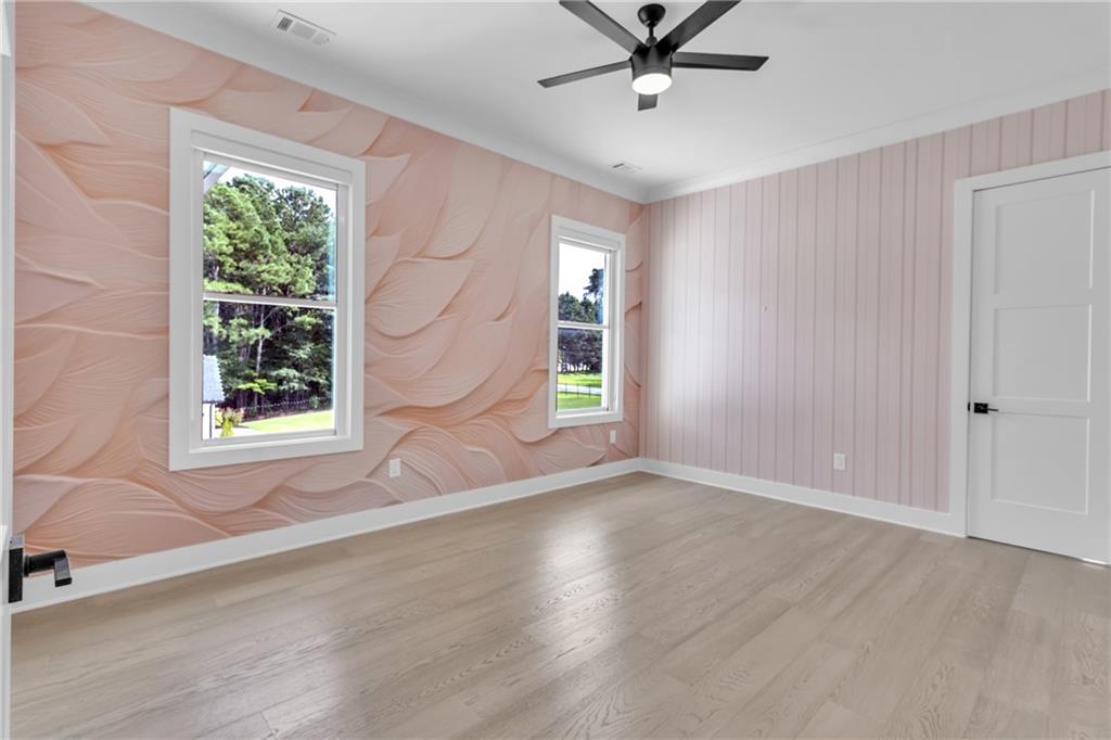3671 Hamilton Mill Road Buford, GA 30519 - Photo 69 of 111 a view of an empty room with a window and wooden floor