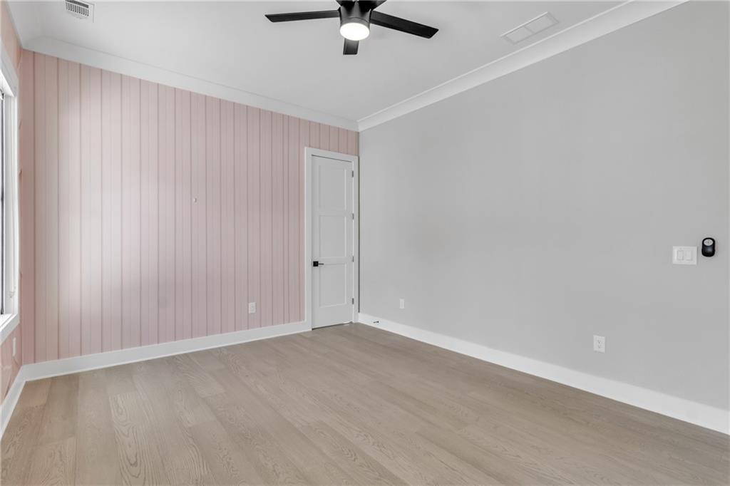 3671 Hamilton Mill Road Buford, GA 30519 - Photo 70 of 111 an empty room with a ceiling fan and window