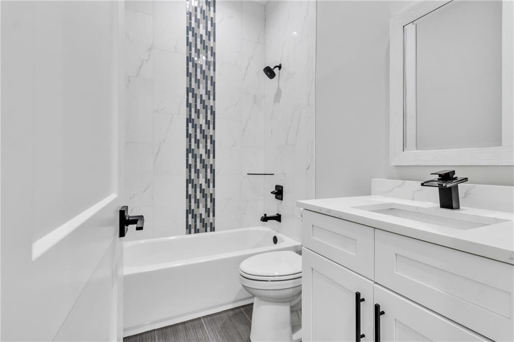 3671 Hamilton Mill Road Buford, GA 30519 - Photo 75 of 111 a bathroom with a sink a toilet and a bathtub