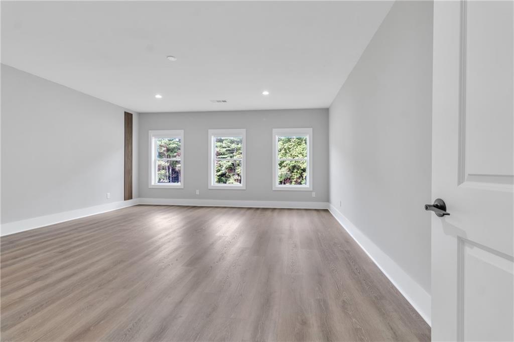 3671 Hamilton Mill Road Buford, GA 30519 - Photo 78 of 111 an empty room with wooden floor and windows