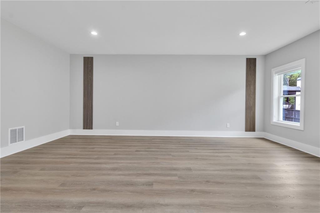 3671 Hamilton Mill Road Buford, GA 30519 - Photo 79 of 111 a view of an empty room with wooden floor and a window