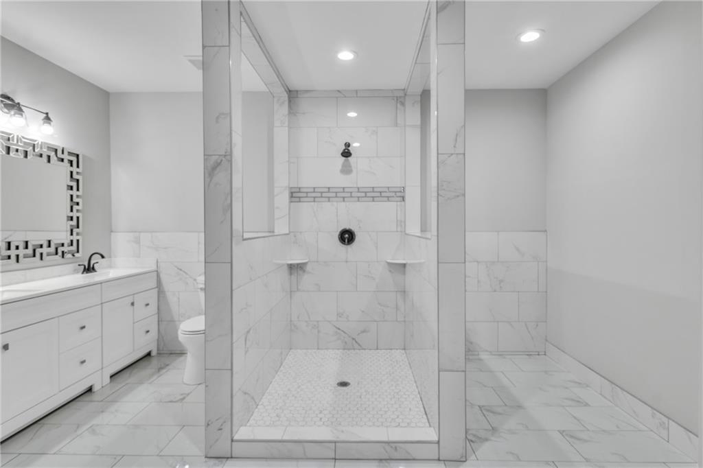 3671 Hamilton Mill Road Buford, GA 30519 - Photo 89 of 111 a bathroom with a shower sink and mirror