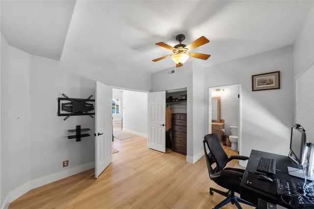 a view of a workspace with furniture and a window