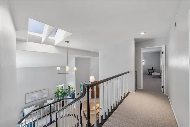 a view of a hallway to a livingroom with furniture