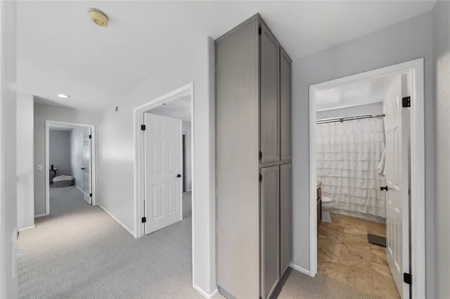 a bedroom with a white bed and white walls