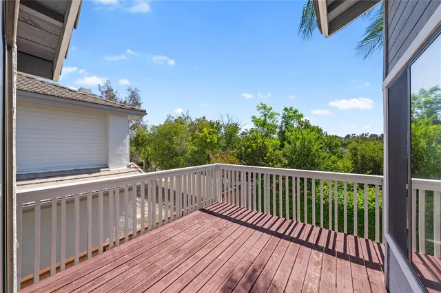 a view of balcony with wooden floor and fence