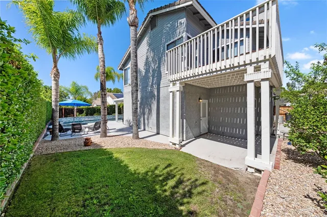 a swimming pool with outdoor seating yard and barbeque oven