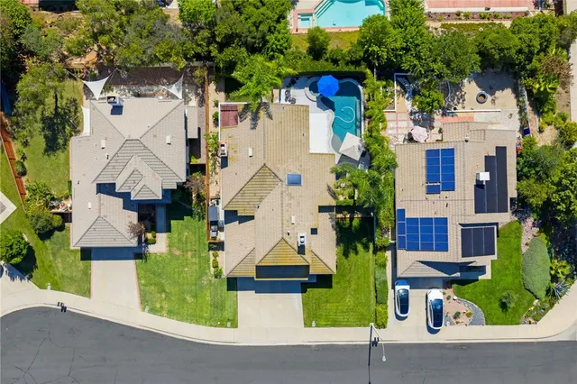an aerial view of multiple houses with a yard