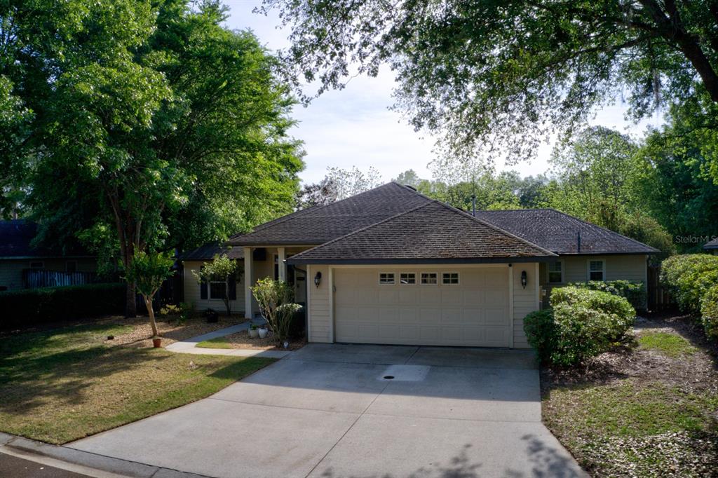 7105 Southwest 85 Terrace Gainesville, FL 32608 - Photo 1 of 1 a view of a house with a yard plants and large tree