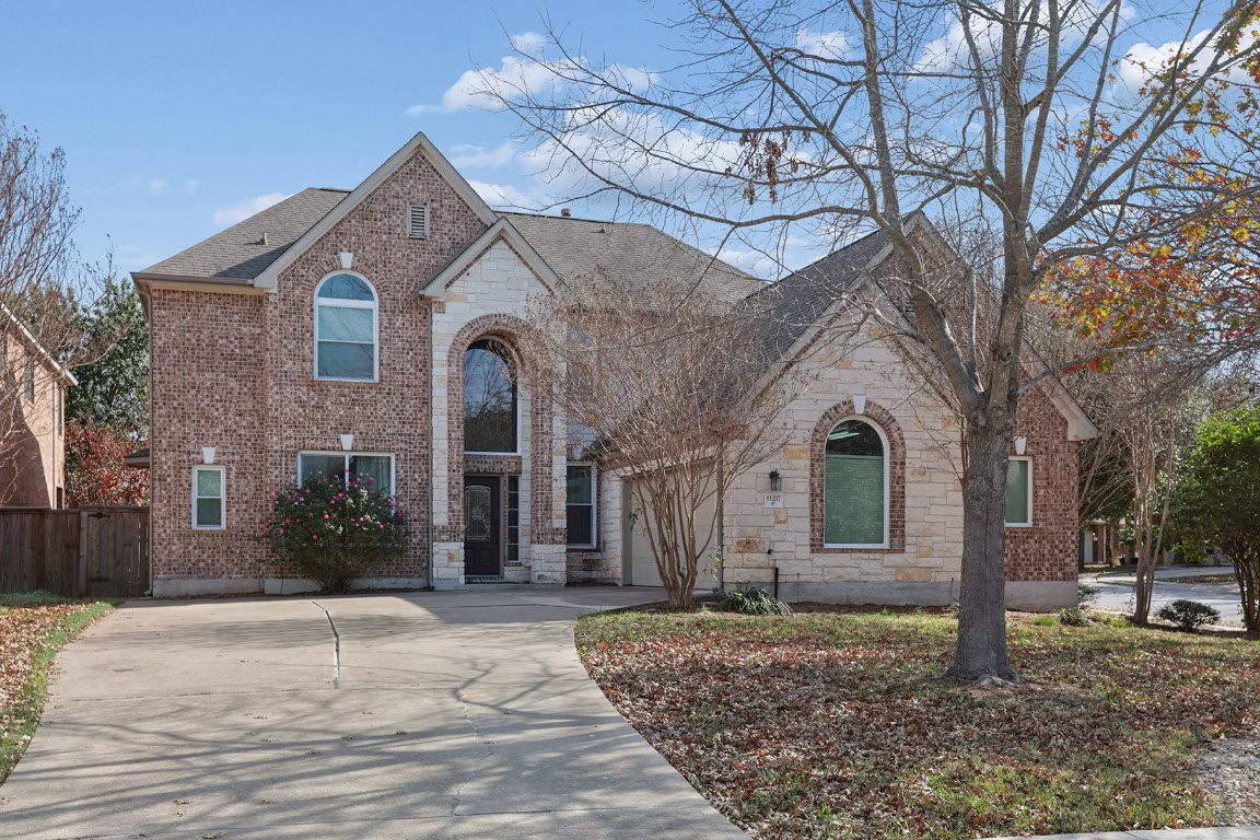 11217 Terrace Meadow Way Manor, TX 78653 - Photo 2 of 33 View of front of property with brick siding, stone siding, driveway, and roof with shingles