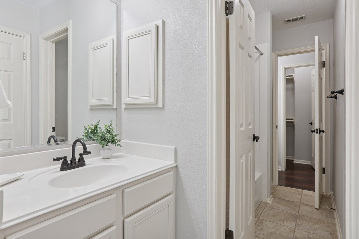 11217 Terrace Meadow Way Manor, TX 78653 - Photo 22 of 33 Bathroom featuring vanity and light tile patterned floors