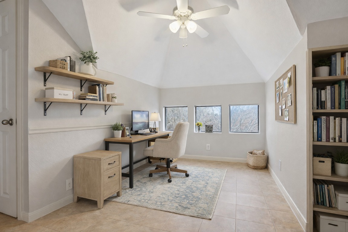 11217 Terrace Meadow Way Manor, TX 78653 - Photo 24 of 33 Office area with ceiling fan, light tile patterned floors, built in features, and lofted ceiling