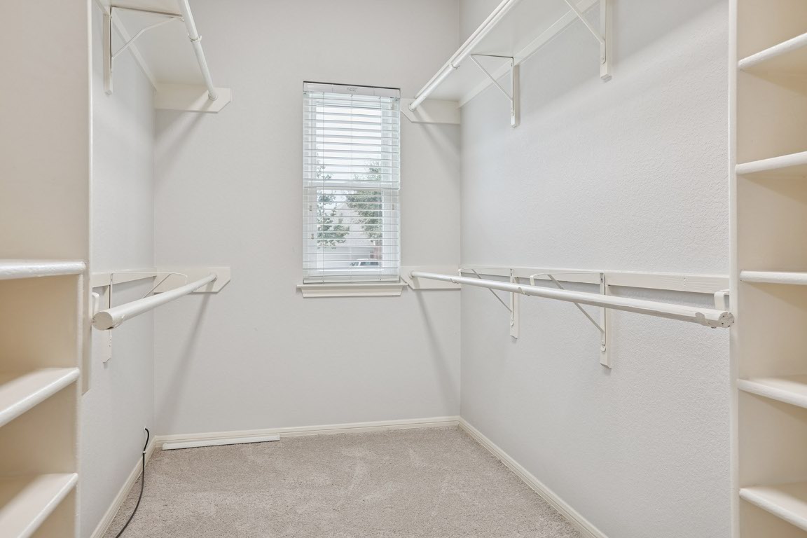 11217 Terrace Meadow Way Manor, TX 78653 - Photo 28 of 33 Walk in closet featuring light carpet