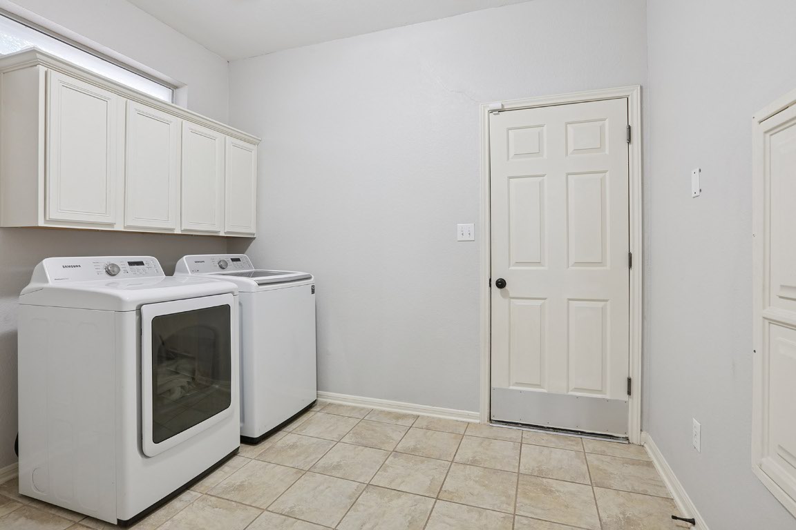 11217 Terrace Meadow Way Manor, TX 78653 - Photo 32 of 33 Washroom featuring washer and dryer and cabinet space