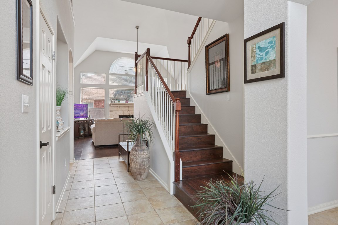 11217 Terrace Meadow Way Manor, TX 78653 - Photo 5 of 33 Stairway featuring tile patterned flooring and a textured wall