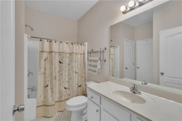 a bathroom with a sink toilet a mirror and shower