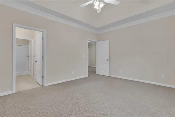a view of an empty room with a chandelier fan