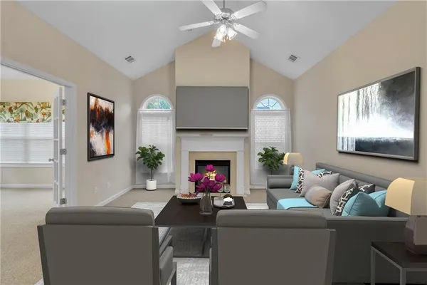 a living room with furniture a fireplace and potted plants