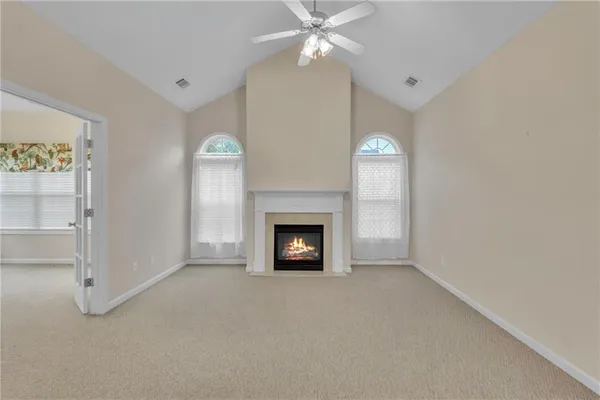 a view of a livingroom with a fireplace and ceiling fan