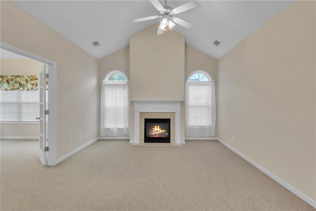 4557 Caleb Crossing, Unit 71 Powder Springs, GA 30127 - Photo 5 of 23 a view of a livingroom with a fireplace and ceiling fan