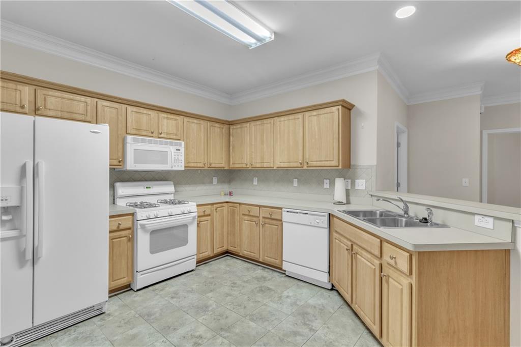 4557 Caleb Crossing, Unit 71 Powder Springs, GA 30127 - Photo 8 of 23 a kitchen with a sink stove and refrigerator