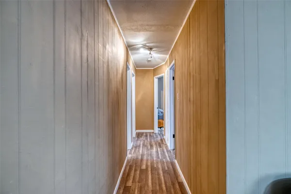 a view of gallery with wooden floor