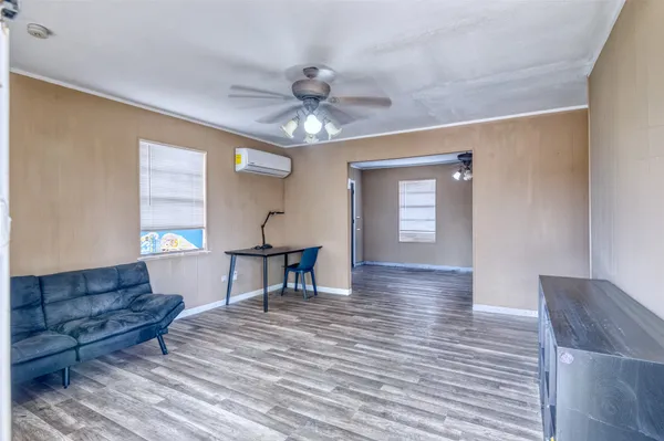 a living room with furniture and a wooden floor
