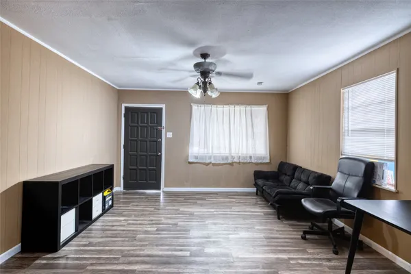 a living room with furniture windows and a chandelier
