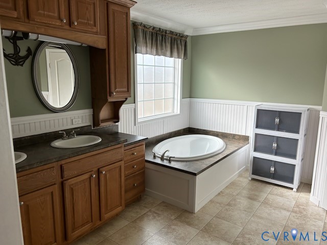 15910 Nobles Road Disputanta, VA 23842 - Photo 27 of 38 Bathroom featuring a wainscoted wall, vanity, a ga
