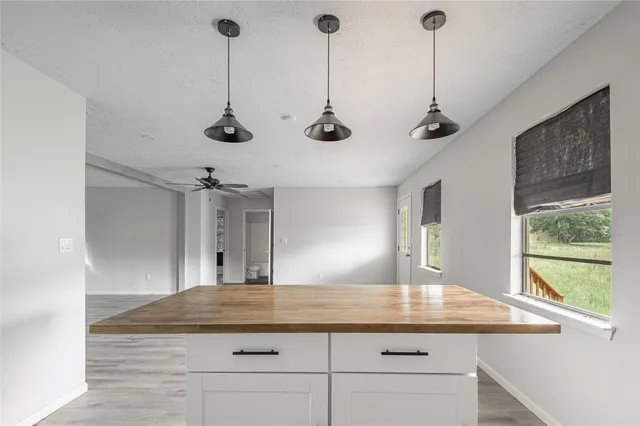a kitchen with kitchen island a counter space a sink and appliances