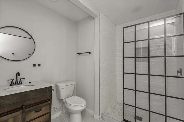 a bathroom with a toilet a sink and a mirror