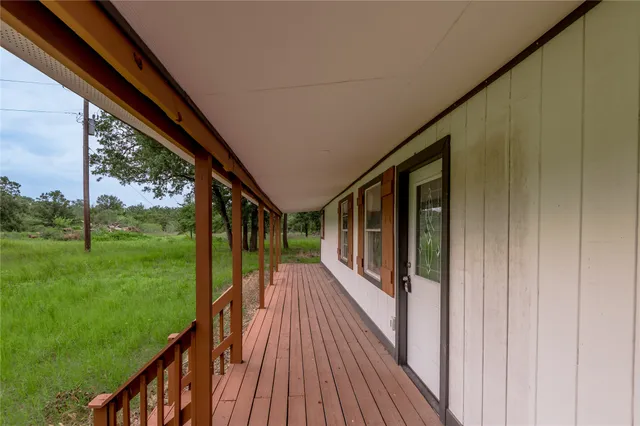 a view of balcony with wooden floor
