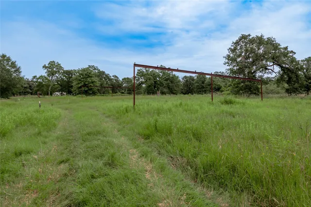 a view of a garden with a building in the background