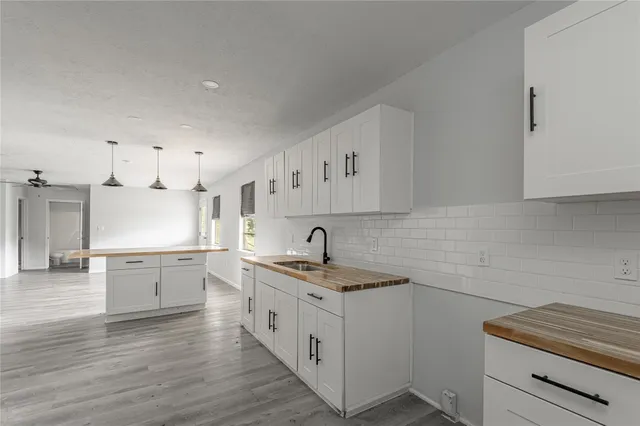 a kitchen with granite countertop white cabinets and white appliances