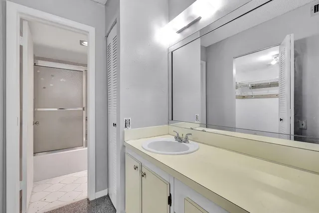 a bathroom with a shower and a bath tub