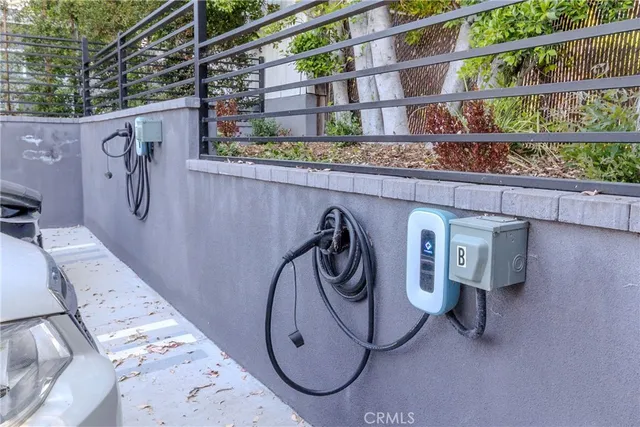 a view of a chair and table in backyard of the house