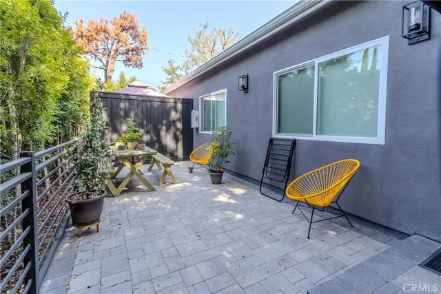an outdoor space with furniture and umbrella